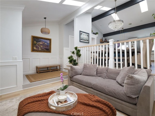 3504 Hightide Dr, Rancho Palos Verdes, CA 90275 - living room with a chandelier, wood finished floors, ornamental molding, wainscoting, and a decorative wall
