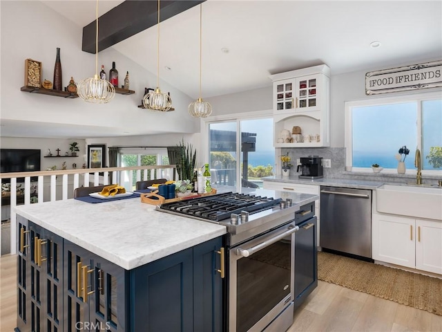 3504 Hightide Dr, Rancho Palos Verdes, CA 90275 - kitchen with appliances with stainless steel finishes, a sink, blue cabinetry, white cabinetry, and light wood finished floors
