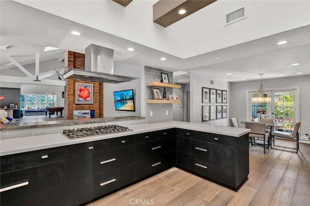 1821 Overview Cir, North Tustin, CA 92705 - kitchen with dark cabinetry, stainless steel gas stovetop, a peninsula, light wood-type flooring, and recessed lighting