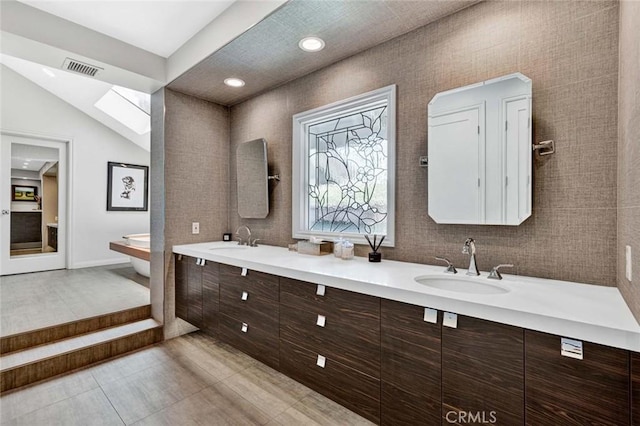1821 Overview Cir, North Tustin, CA 92705 - bathroom with double vanity, a skylight, and recessed lighting