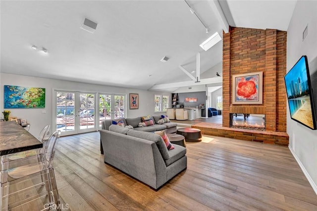 1821 Overview Cir, North Tustin, CA 92705 - living area with french doors, hardwood / wood-style floors, beamed ceiling, a brick fireplace, and high vaulted ceiling