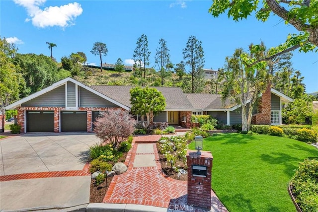 1821 Overview Cir, North Tustin, CA 92705 - view of front facade featuring driveway, a front yard, a garage, and brick siding
