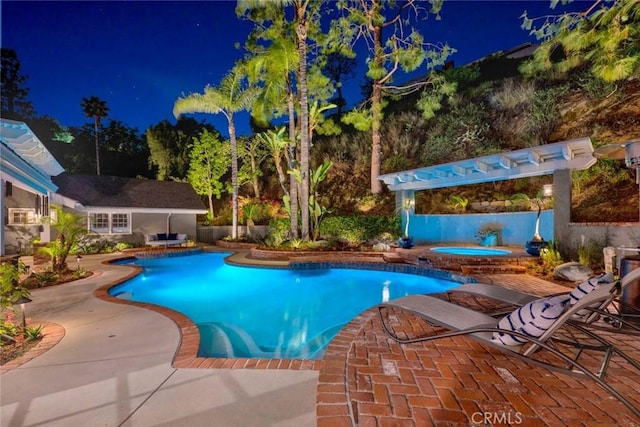 1821 Overview Cir, North Tustin, CA 92705 - pool at night featuring an in-ground hot tub and a patio