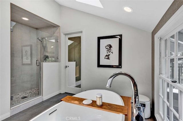 1821 Overview Cir, North Tustin, CA 92705 - bathroom with lofted ceiling, a stall shower, a soaking tub, wood finished floors, and a skylight
