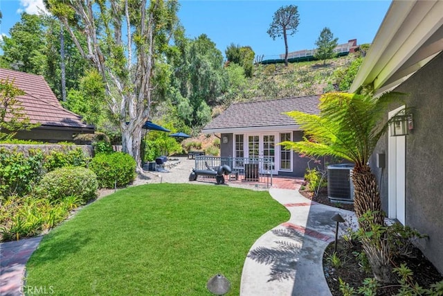 1821 Overview Cir, North Tustin, CA 92705 - view of green lawn featuring central AC unit, a patio, and french doors