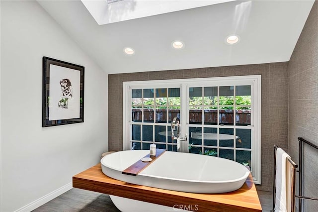 1821 Overview Cir, North Tustin, CA 92705 - dining space featuring vaulted ceiling, recessed lighting, a skylight, baseboards, and wood finished floors