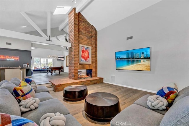 1821 Overview Cir, North Tustin, CA 92705 - living area featuring wood finished floors, beamed ceiling, high vaulted ceiling, a skylight, and a chandelier