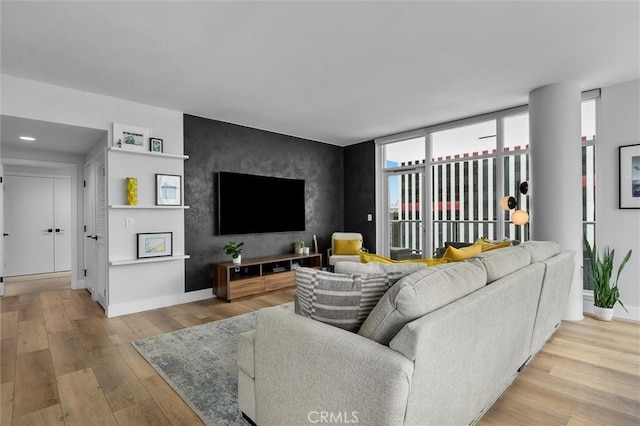 400 W Ocean Blvd Unit 605, Long Beach, CA 90802 - living area with baseboards, wood finished floors, an accent wall, and recessed lighting