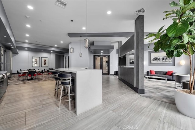400 W Ocean Blvd Unit 605, Long Beach, CA 90802 - kitchen with open floor plan, modern cabinets, light countertops, a kitchen breakfast bar, and recessed lighting