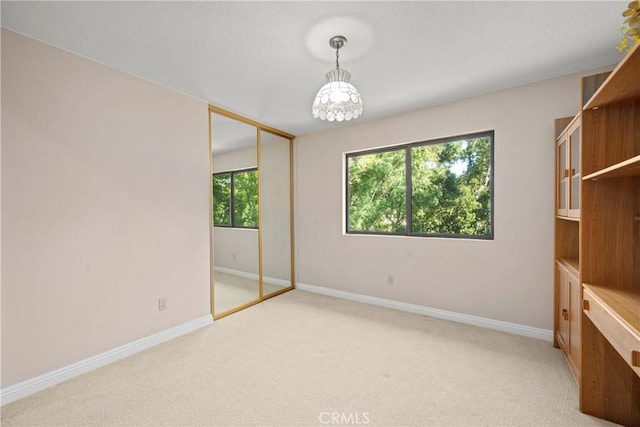 10139 Sun Valley Dr, Rancho Cucamonga, CA 91737 - unfurnished bedroom featuring light colored carpet, baseboards, a chandelier, and a closet