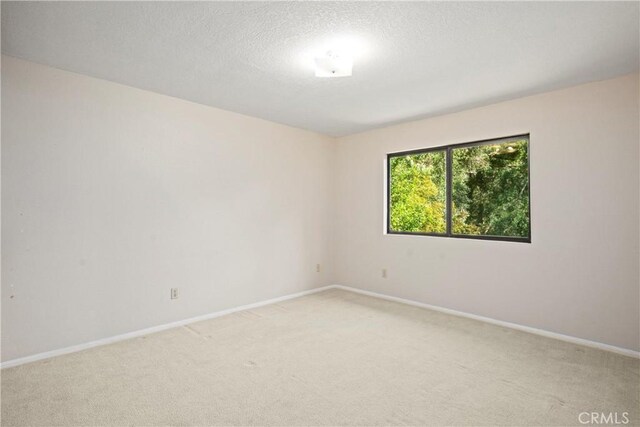 10139 Sun Valley Dr, Rancho Cucamonga, CA 91737 - spare room featuring light colored carpet, baseboards, and a textured ceiling
