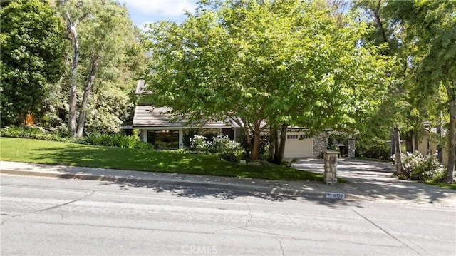 10139 Sun Valley Dr, Rancho Cucamonga, CA 91737 - obstructed view of property featuring concrete driveway, a front yard, and an attached garage