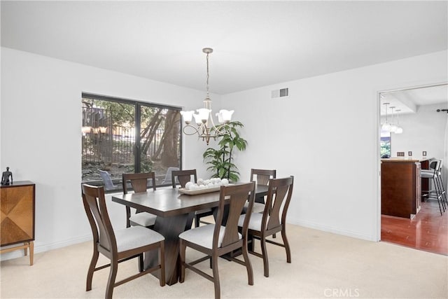10139 Sun Valley Dr, Rancho Cucamonga, CA 91737 - dining space featuring a chandelier, light colored carpet, and baseboards