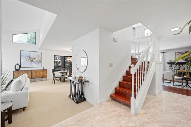 10139 Sun Valley Dr, Rancho Cucamonga, CA 91737 - stairway featuring plenty of natural light, a fireplace, and marble look tile flooring