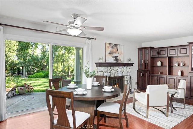 10139 Sun Valley Dr, Rancho Cucamonga, CA 91737 - dining area featuring a ceiling fan, light wood-type flooring, and a fireplace