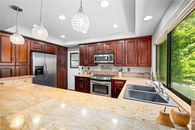 10139 Sun Valley Dr, Rancho Cucamonga, CA 91737 - kitchen featuring stainless steel appliances, a sink, a chandelier, a raised ceiling, and pendant lighting