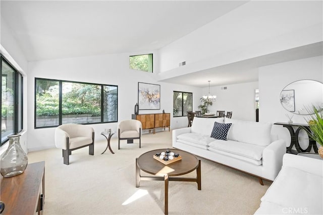 10139 Sun Valley Dr, Rancho Cucamonga, CA 91737 - living room with light colored carpet, high vaulted ceiling, a chandelier, and baseboards