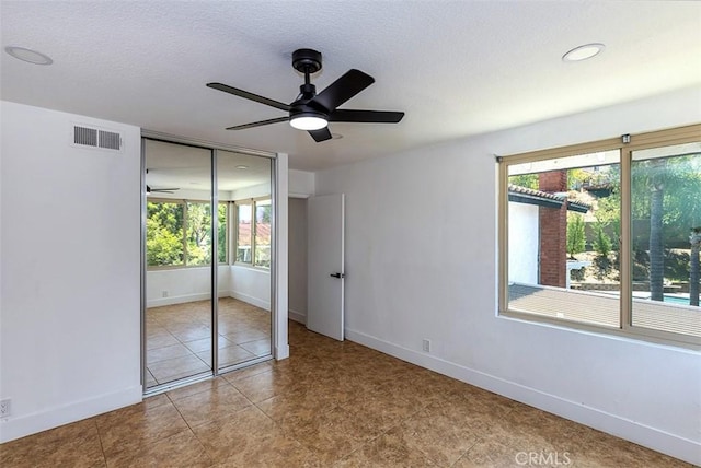 1250 Kinglake Dr, Diamond Bar, CA 91789 - unfurnished bedroom with multiple windows, a closet, a textured ceiling, and ceiling fan