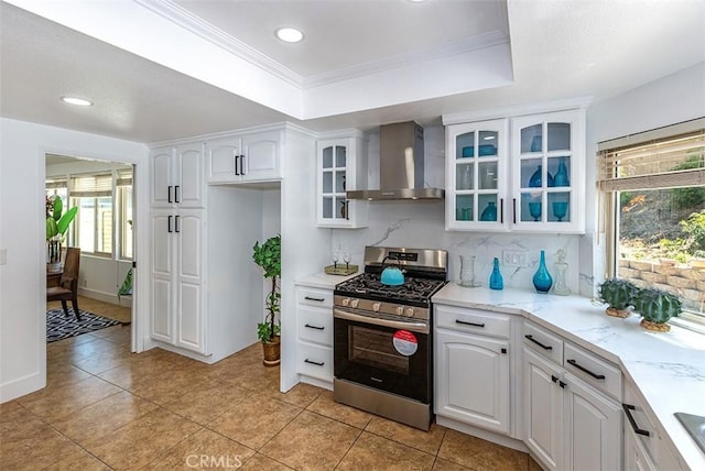 1250 Kinglake Dr, Diamond Bar, CA 91789 - kitchen with wall chimney range hood, gas stove, a tray ceiling, decorative backsplash, and glass insert cabinets