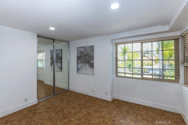 1250 Kinglake Dr, Diamond Bar, CA 91789 - unfurnished bedroom with multiple windows, recessed lighting, a closet, and a textured ceiling