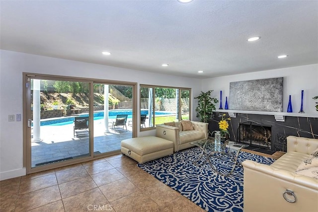 1250 Kinglake Dr, Diamond Bar, CA 91789 - living room with recessed lighting, a tiled fireplace, a textured ceiling, and light tile patterned floors