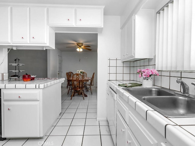 29412 Carmel Rd, Menifee, CA 92586 - kitchen with tile counters, ceiling fan, a sink, and white cabinetry