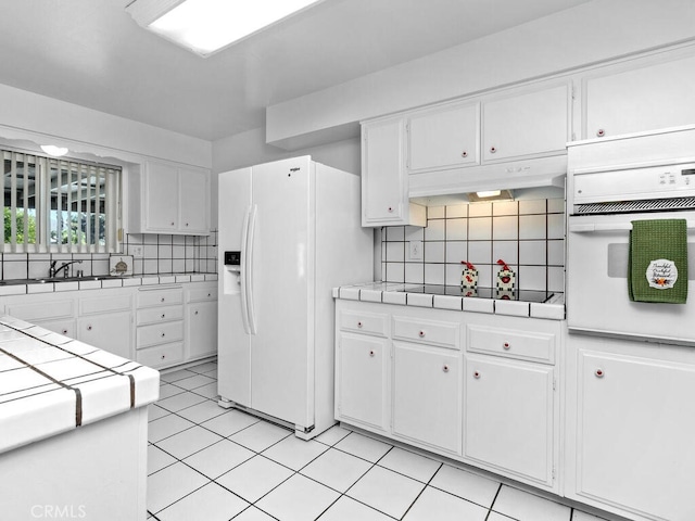 29412 Carmel Rd, Menifee, CA 92586 - kitchen with white appliances, tile countertops, white cabinets, and backsplash
