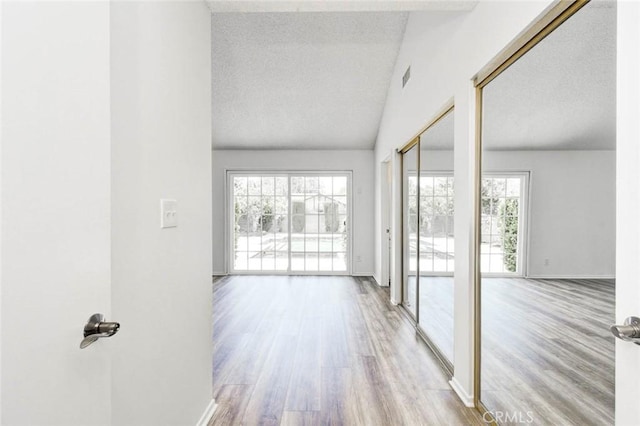 1919 Austin Ct, Claremont, CA 91711 - hallway featuring wood finished floors, vaulted ceiling, baseboards, and a textured ceiling