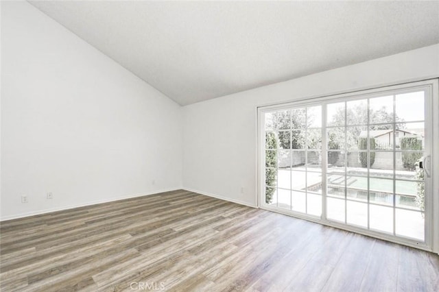 1919 Austin Ct, Claremont, CA 91711 - spare room featuring vaulted ceiling, wood finished floors, plenty of natural light, and baseboards
