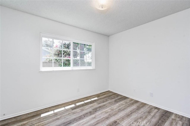 1919 Austin Ct, Claremont, CA 91711 - unfurnished room featuring wood finished floors, a textured ceiling, and baseboards
