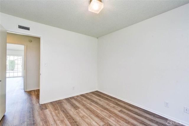 1919 Austin Ct, Claremont, CA 91711 - spare room with wood finished floors, baseboards, and a textured ceiling