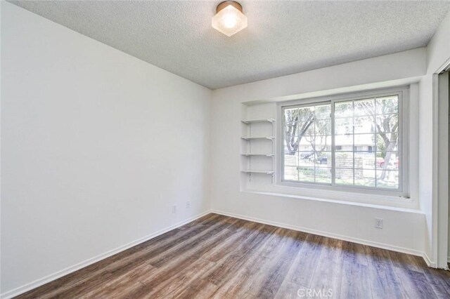1919 Austin Ct, Claremont, CA 91711 - spare room featuring a textured ceiling, dark wood finished floors, and baseboards