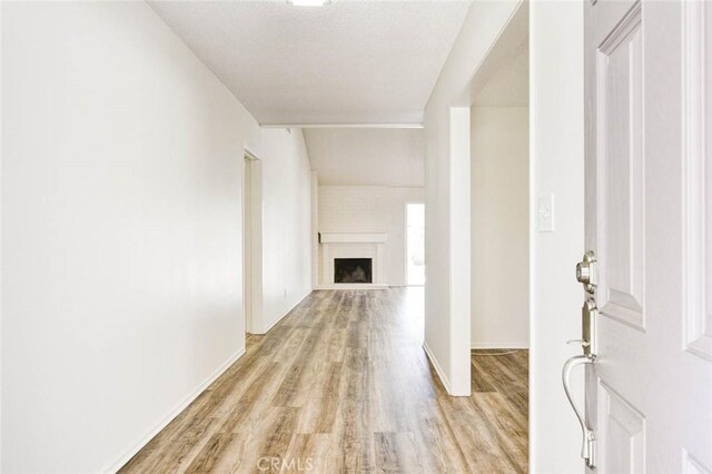 1919 Austin Ct, Claremont, CA 91711 - entryway featuring light wood-style floors, baseboards, and a fireplace with raised hearth