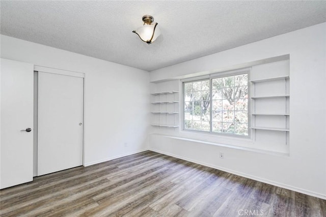1919 Austin Ct, Claremont, CA 91711 - unfurnished bedroom featuring wood finished floors, a closet, a textured ceiling, and baseboards
