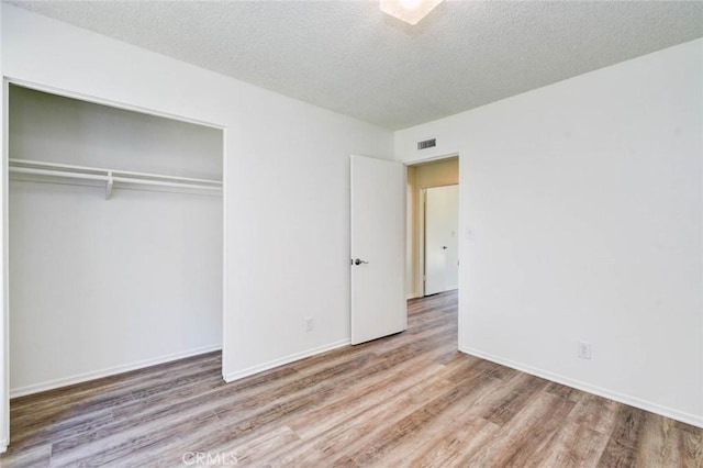 1919 Austin Ct, Claremont, CA 91711 - unfurnished bedroom featuring wood finished floors, a closet, a textured ceiling, and baseboards