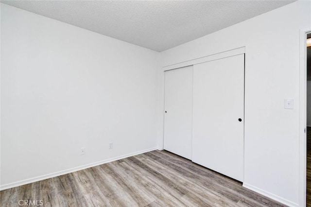 1919 Austin Ct, Claremont, CA 91711 - unfurnished bedroom with wood finished floors, a closet, and baseboards