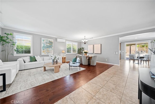 7626 Soaring Bird Ct, Eastvale, CA 92880 - living area featuring a chandelier, crown molding, a wall mounted air conditioner, tile patterned floors, and baseboards