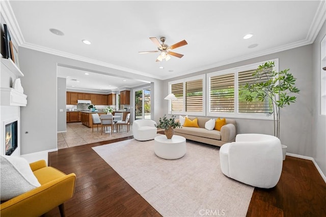 7626 Soaring Bird Ct, Eastvale, CA 92880 - living area featuring a ceiling fan, baseboards, recessed lighting, light wood-style flooring, and a glass covered fireplace