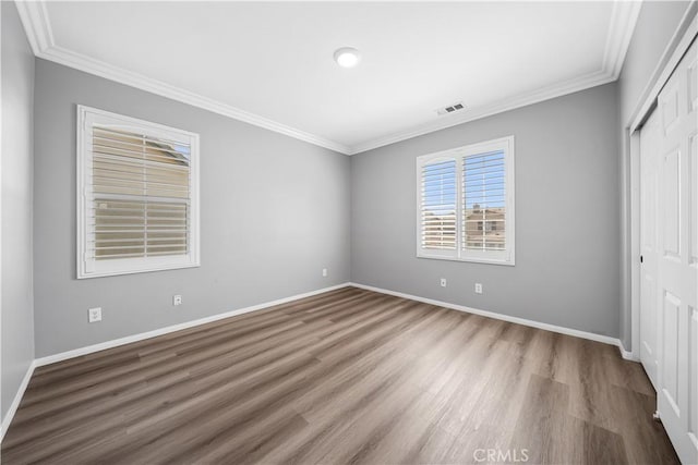7626 Soaring Bird Ct, Eastvale, CA 92880 - unfurnished bedroom featuring ornamental molding, wood finished floors, a closet, and baseboards