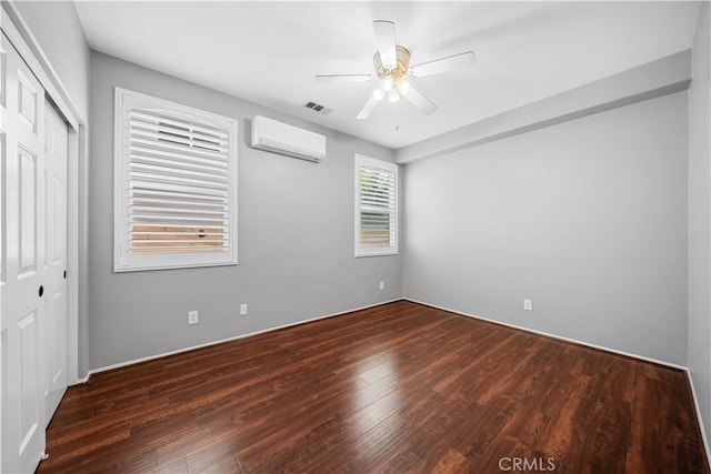 7626 Soaring Bird Ct, Eastvale, CA 92880 - unfurnished bedroom featuring a wall unit AC, wood finished floors, a closet, and a ceiling fan