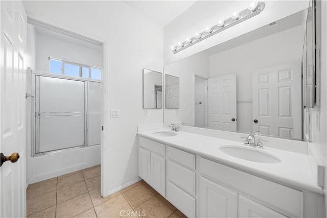 7626 Soaring Bird Ct, Eastvale, CA 92880 - bathroom with tile patterned floors, enclosed tub / shower combo, double vanity, and baseboards