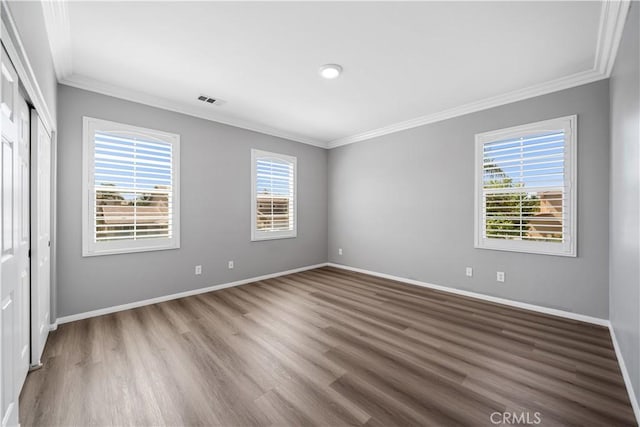 7626 Soaring Bird Ct, Eastvale, CA 92880 - unfurnished bedroom featuring ornamental molding, multiple windows, wood finished floors, and baseboards