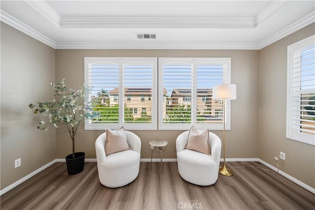 7626 Soaring Bird Ct, Eastvale, CA 92880 - living area featuring a raised ceiling, wood finished floors, crown molding, and baseboards