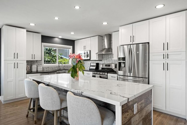 2548 Katherine Ct, El Cajon, CA 92020 - kitchen featuring wall chimney range hood, appliances with stainless steel finishes, a sink, tasteful backsplash, and recessed lighting