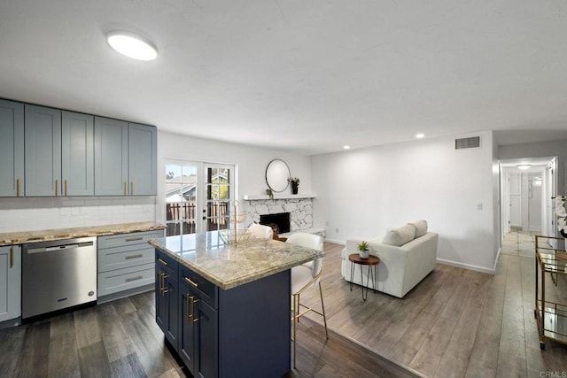 2548 Katherine Ct, El Cajon, CA 92020 - kitchen with stainless steel dishwasher, a kitchen bar, a premium fireplace, open floor plan, and dark wood-style flooring
