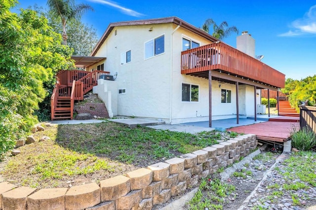 2548 Katherine Ct, El Cajon, CA 92020 - back of property with stairway, a wooden deck, a patio area, and stucco siding