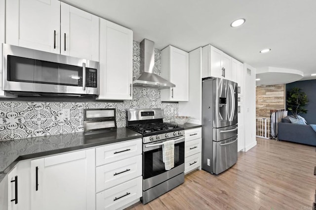 2548 Katherine Ct, El Cajon, CA 92020 - kitchen with appliances with stainless steel finishes, wall chimney range hood, dark countertops, tasteful backsplash, and light wood-style floors