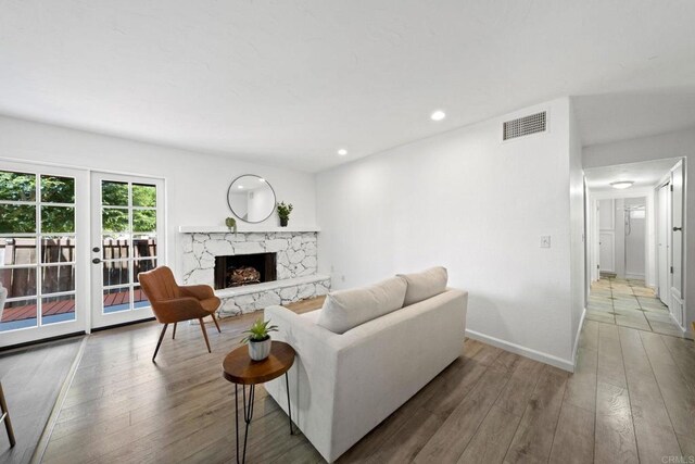 2548 Katherine Ct, El Cajon, CA 92020 - living room featuring hardwood / wood-style flooring, french doors, a premium fireplace, baseboards, and recessed lighting