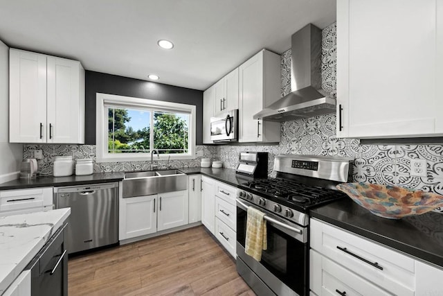 2548 Katherine Ct, El Cajon, CA 92020 - kitchen featuring appliances with stainless steel finishes, wall chimney exhaust hood, a sink, tasteful backsplash, and white cabinets