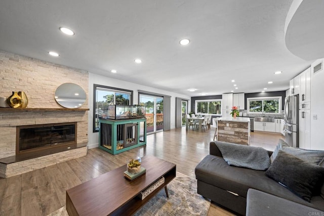 2548 Katherine Ct, El Cajon, CA 92020 - living room featuring recessed lighting, a stone fireplace, and light wood-style flooring